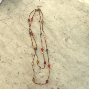 Long continuous beaded necklace.